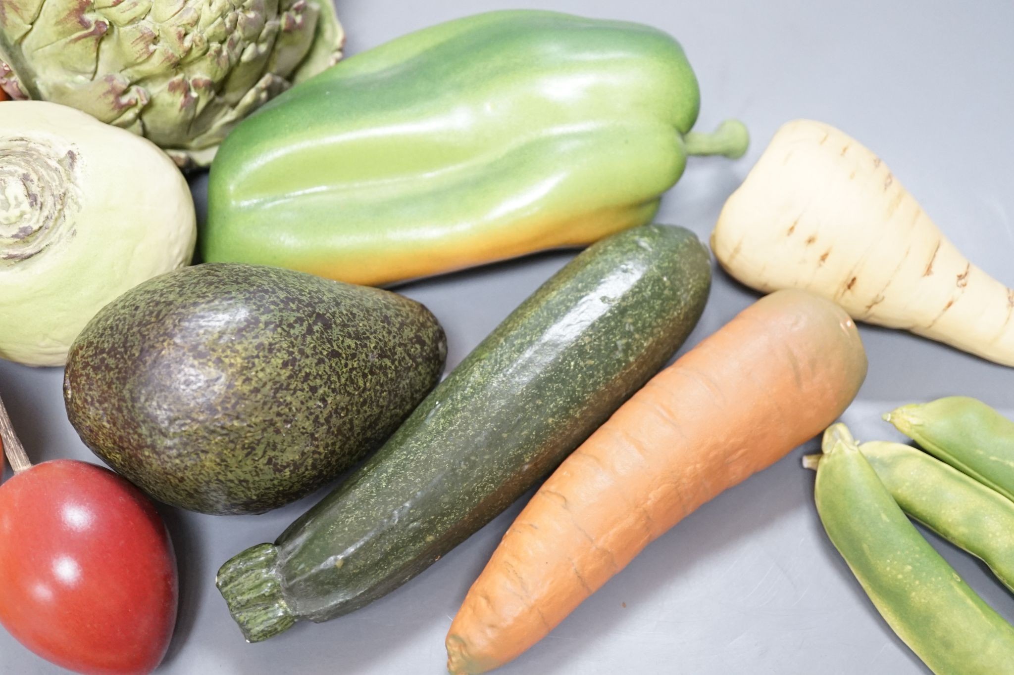 A collection of vintage Penkridge ceramic vegetables including an artichoke, avocado, peppers and asparagus (19 items)